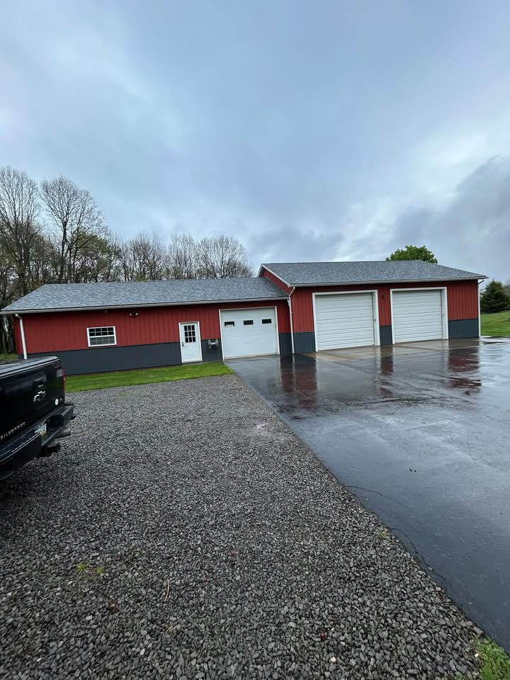 Red garage with new roof completed by Oil Region Roofing in Venango County PA