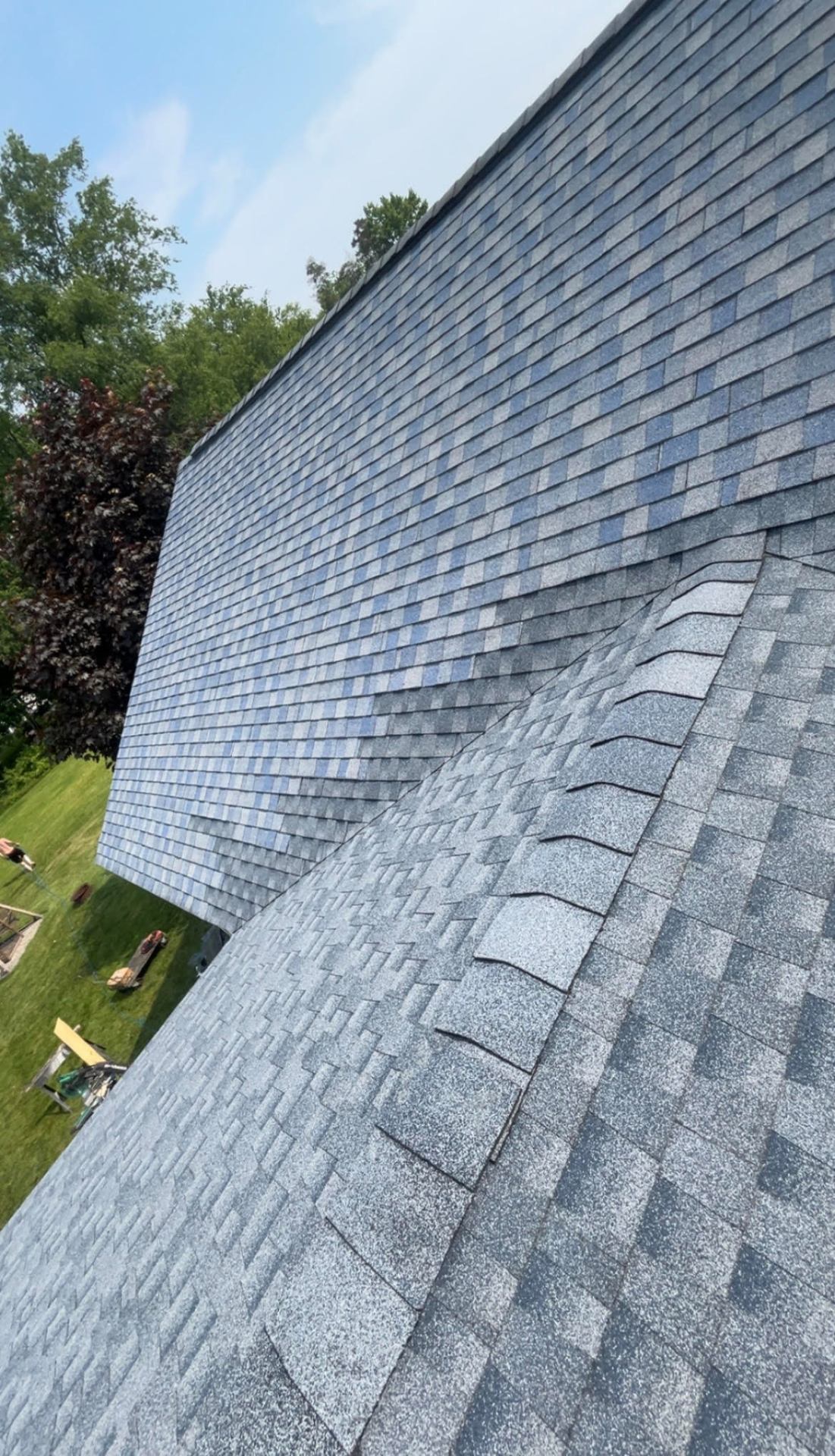 Freshly installed architectural shingles with crisp ridge line after roof repair