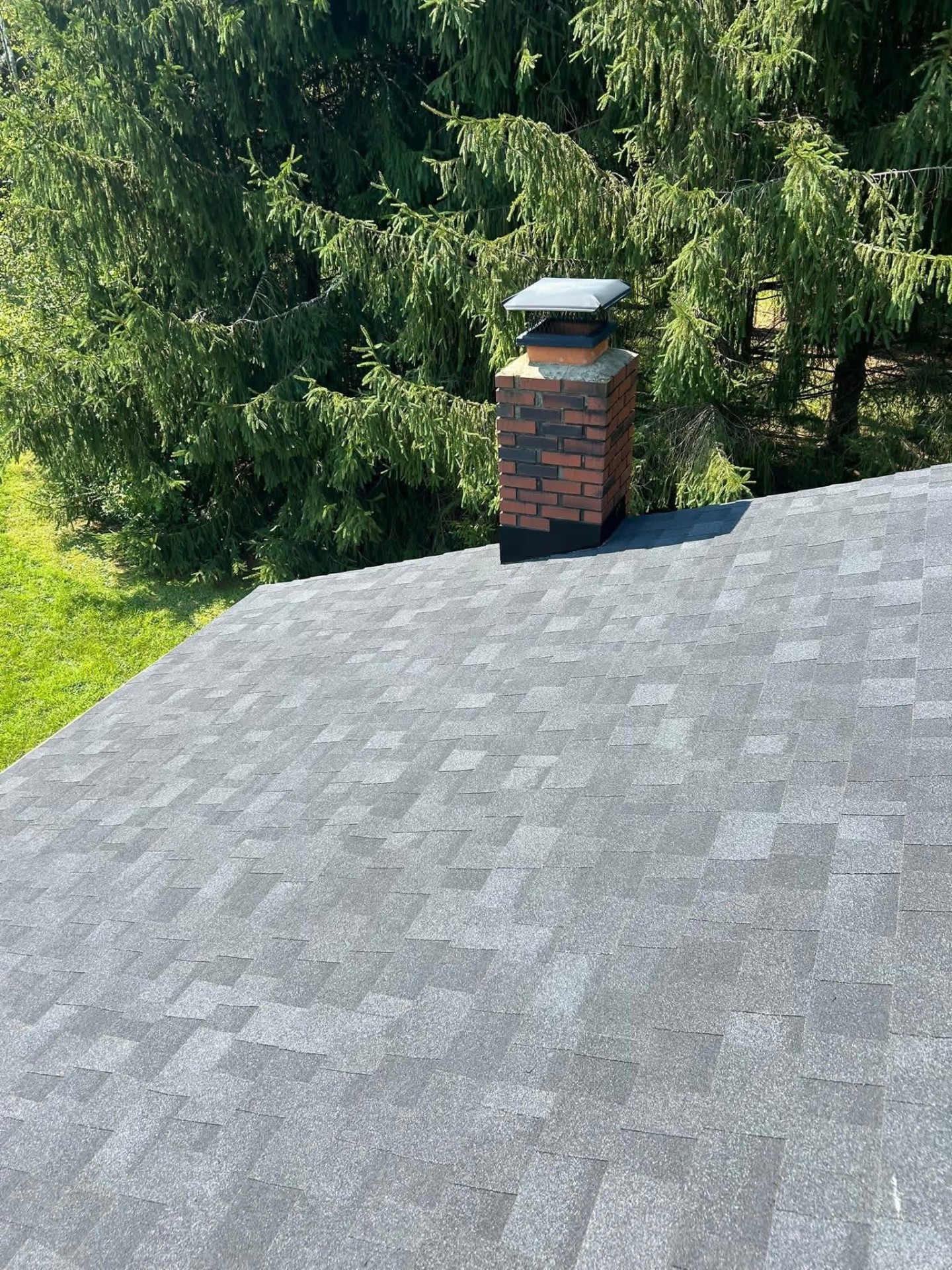 Premium architectural shingle roof with brick chimney and new flashing
